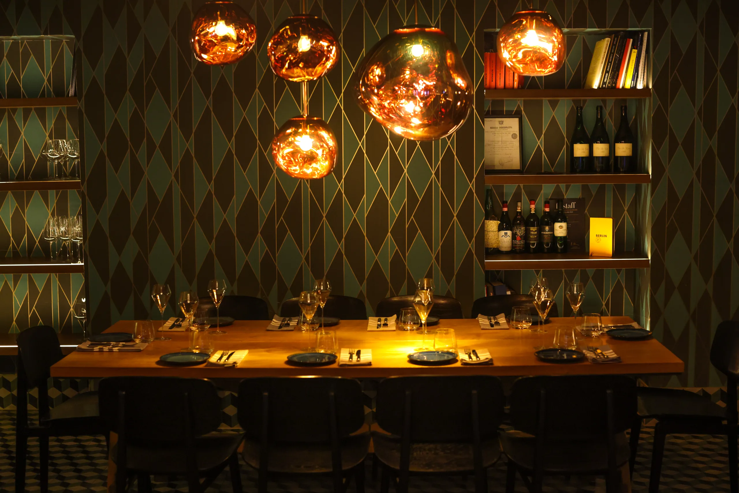 Big Tables Party room with copper pendant lights above the long dining table